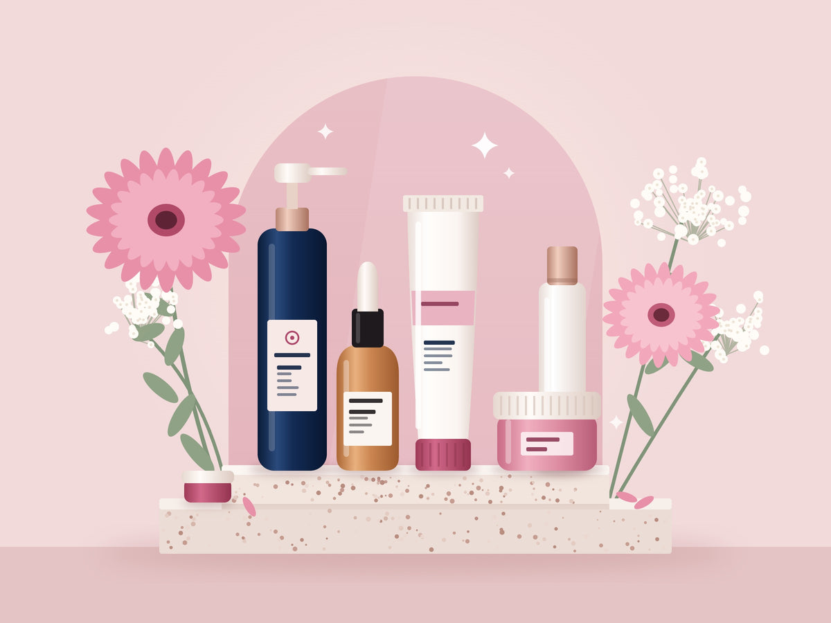 Skincare bottles, a tube and a jar on a stone plinth with pink gerberas